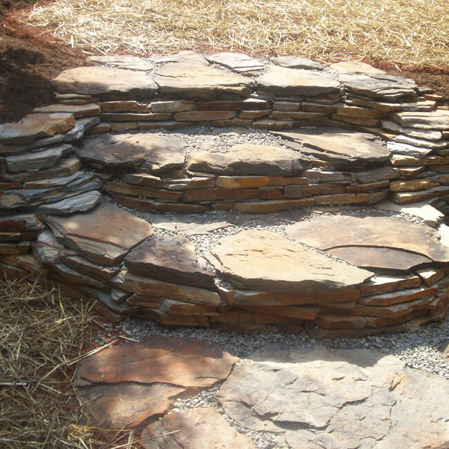 Cross view of 3 tiered Tennessee boulder stairway through Velvet Gray thin veneer retaining wall