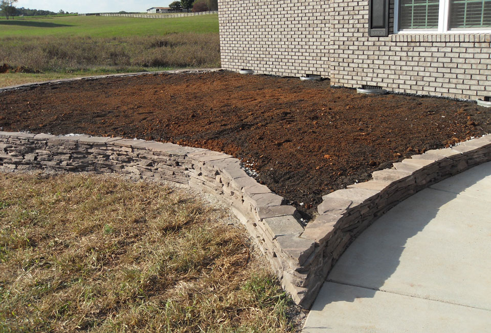 'Colonial Lilac' PA Fieldstone Mortared Stone Retaining Wall Corner where Turf meets Walkway complete w/ Topsoil & Vent Well Covers