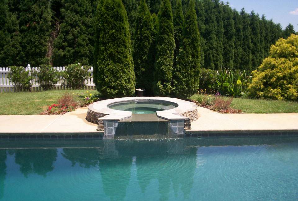 Poolside PA Bluestone Jacuzzi accented w/ 'Emerald Green' Arborvitae, Perennial Garden, Ligustrum & Taller Conifers as backdrop