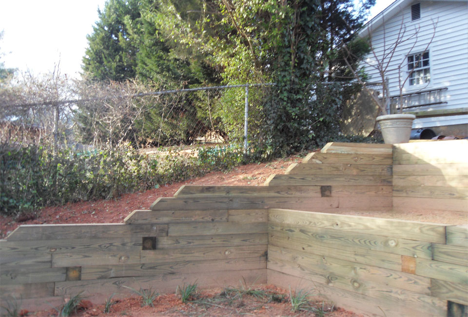 Multi-Level Tiered Timber Retaining Walls 'Stairing Down' rapidly on Upper Left Hillside of Back Yard featuring 'Deadman' Anchor System