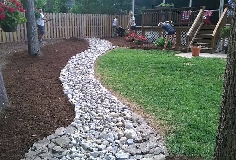 Dry Creek Bed featuring Delaware Valley River Slicks separating Natural Area from Lawn w/ PA Bluestone Thin Veneer Borders